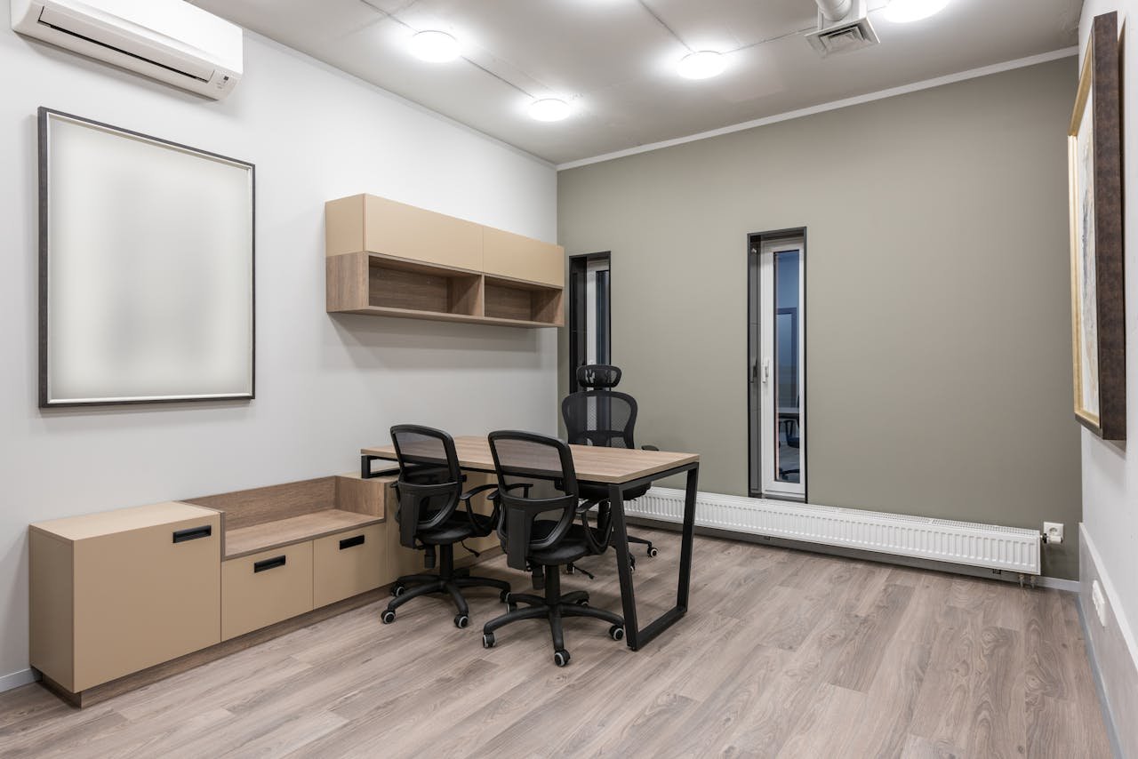 Spacious modern office with minimalist design featuring neutral tones and sleek furniture.